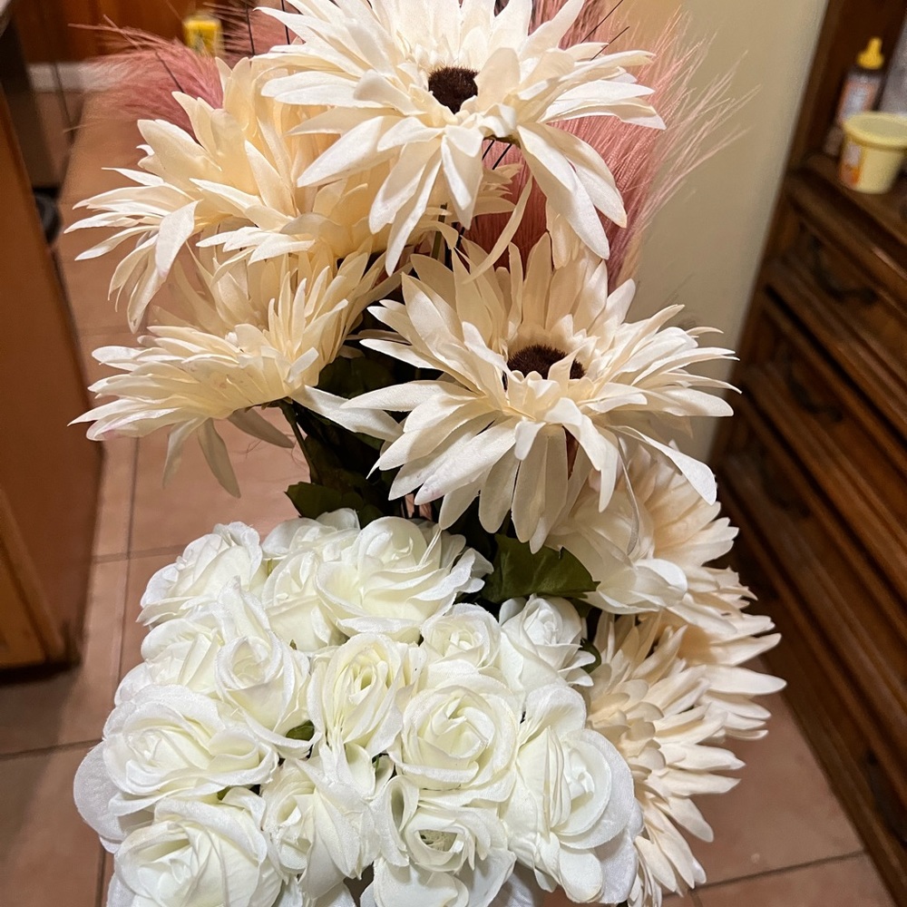Assorted white flowers for home decor. Was used in a Boho themed party.